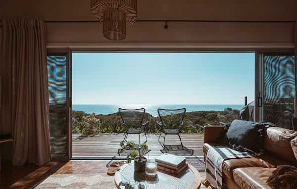 sea facing luxury home terrace having chairs and sofa